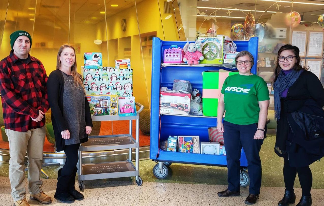 Local 3800 members Brad Sigal, Janaya Martin, Cherrene Horazuk and Marie Dino show off the toys they collected for the U of M’s Masonic Children’s Hospital